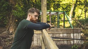 A man alone looking out in forest