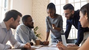5 people brainstorming around a table