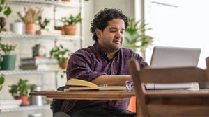 man working at desk on a laptop
