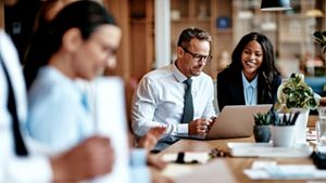 Group of 3 people talking about money or group in a meeting environment