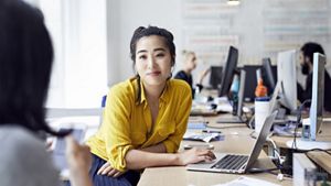 Female colleague interacting with office co-workers