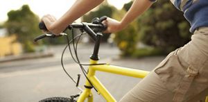 Person riding a yellow bicycle
