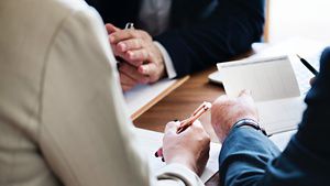 People around a table going through documents