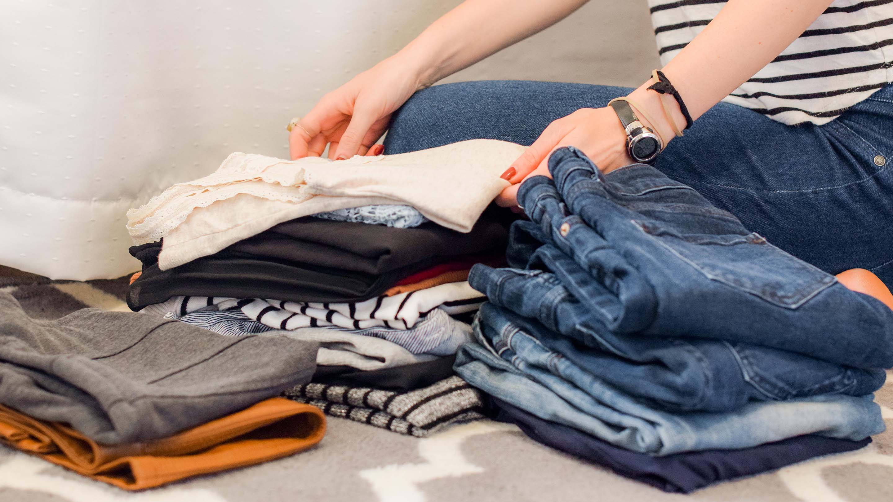 Women organising clothes from wardrobe