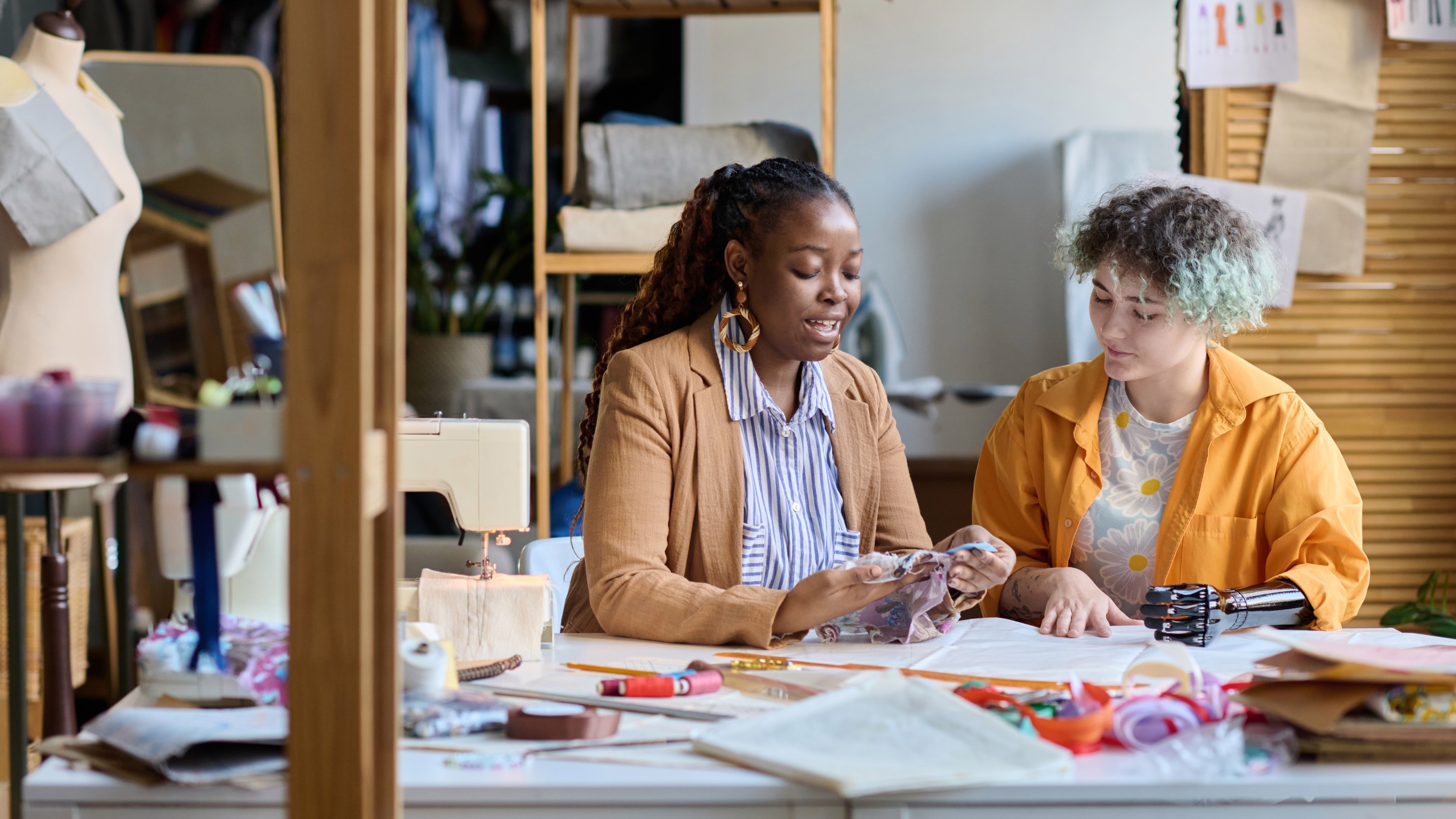 Two women working in a fashion and textiles studio