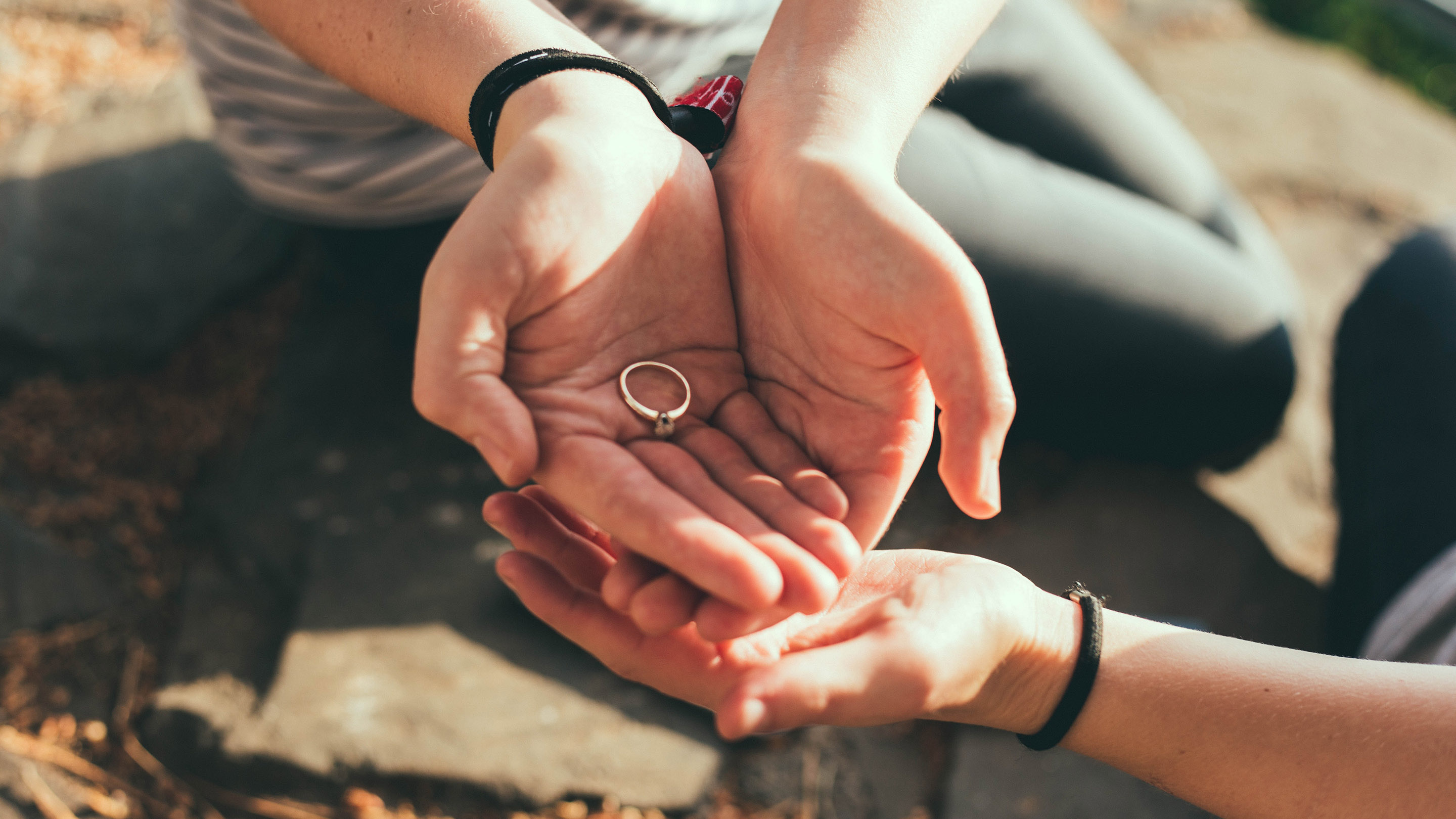 Photo of a wedding ring in person's cupped hands