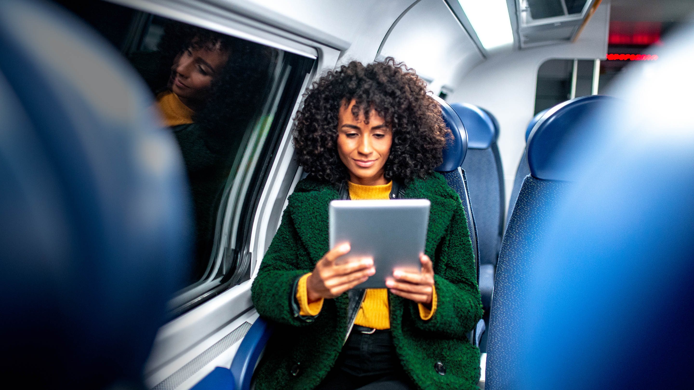 woman on train using tablet