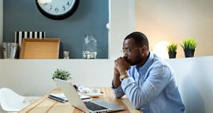 Man in office looking at his laptop