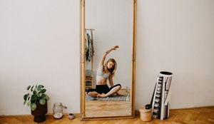 person performing yoga infront of a mirror
