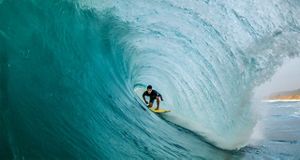 Man surfing inside wave