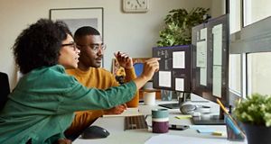 Man and Woman looking at a Computer screen