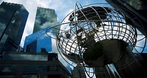 Metal globe in a city landscape