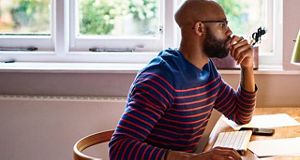 Man looking at a computer sat at a desk