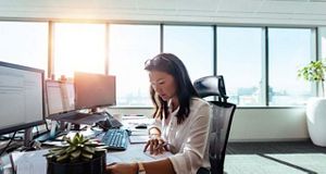 Woman sat at a computer in the office