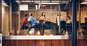 5 people sitting in an office meeting