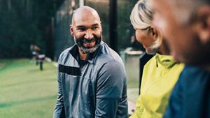 Friends sat together, engaging in conversation with a happy/positive expression on their faces