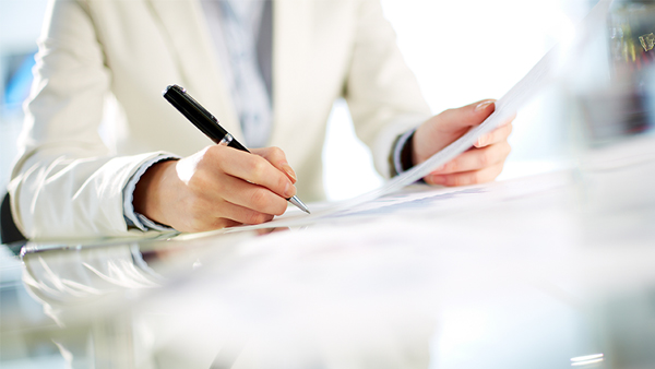 man signing on paper