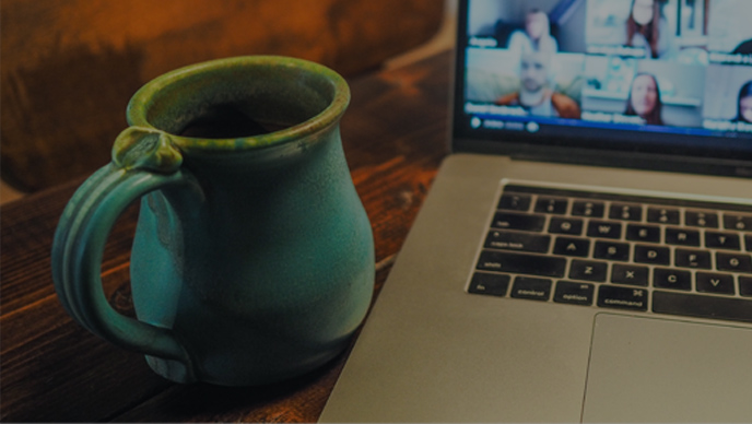 Laptop on a desk with a mug