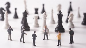 small figurines on a chess board