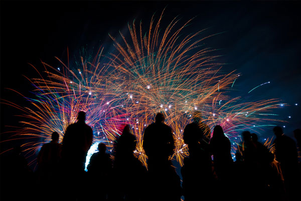 picture- silhouettes in front of colourful fireworks