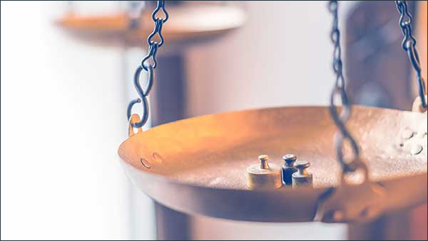 Tiny weights on vintage balance scales