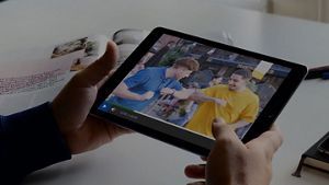 Visual of iPad showing two people laughing
