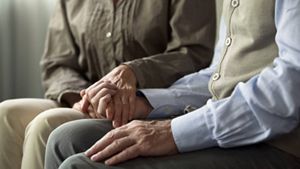 Elderly couple holding hands