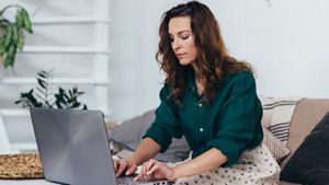 Woman writing on a laptop