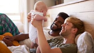 Same-sex couple holding their baby