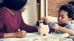 Mother and child counting piggy bank savings