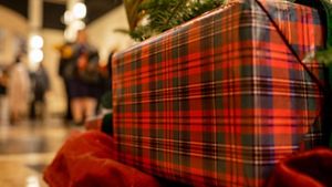 Large Christmas present with people in the background