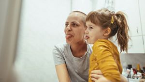 Person with child pulling funny faces
