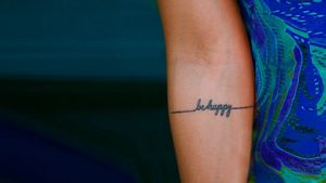 picture of be happy tattoo on an arm