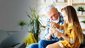 Person with grandchild smiling