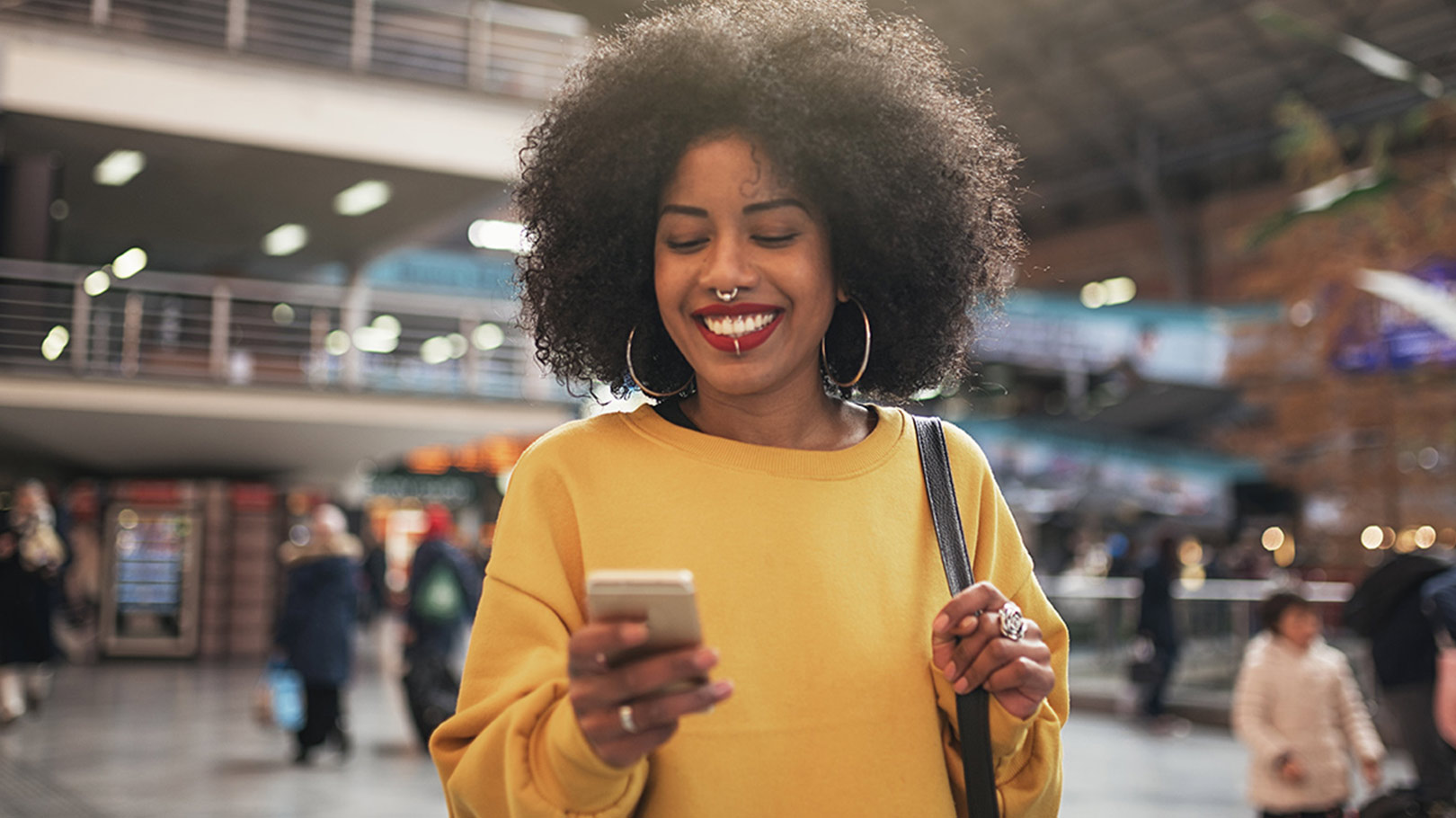 Woman smiling and looking at her phone