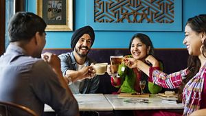 Four people raising a toast at a dining table