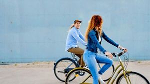 Two people on bicycles looking at each other