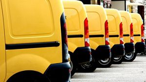 A picture of yellow vans parked in a line
