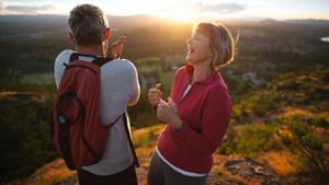 Fit, Active Middle Age Couple Hiking Together At Sunset