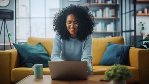 Portrait of a Female in a Stylish Cozy Living Room Using Laptop