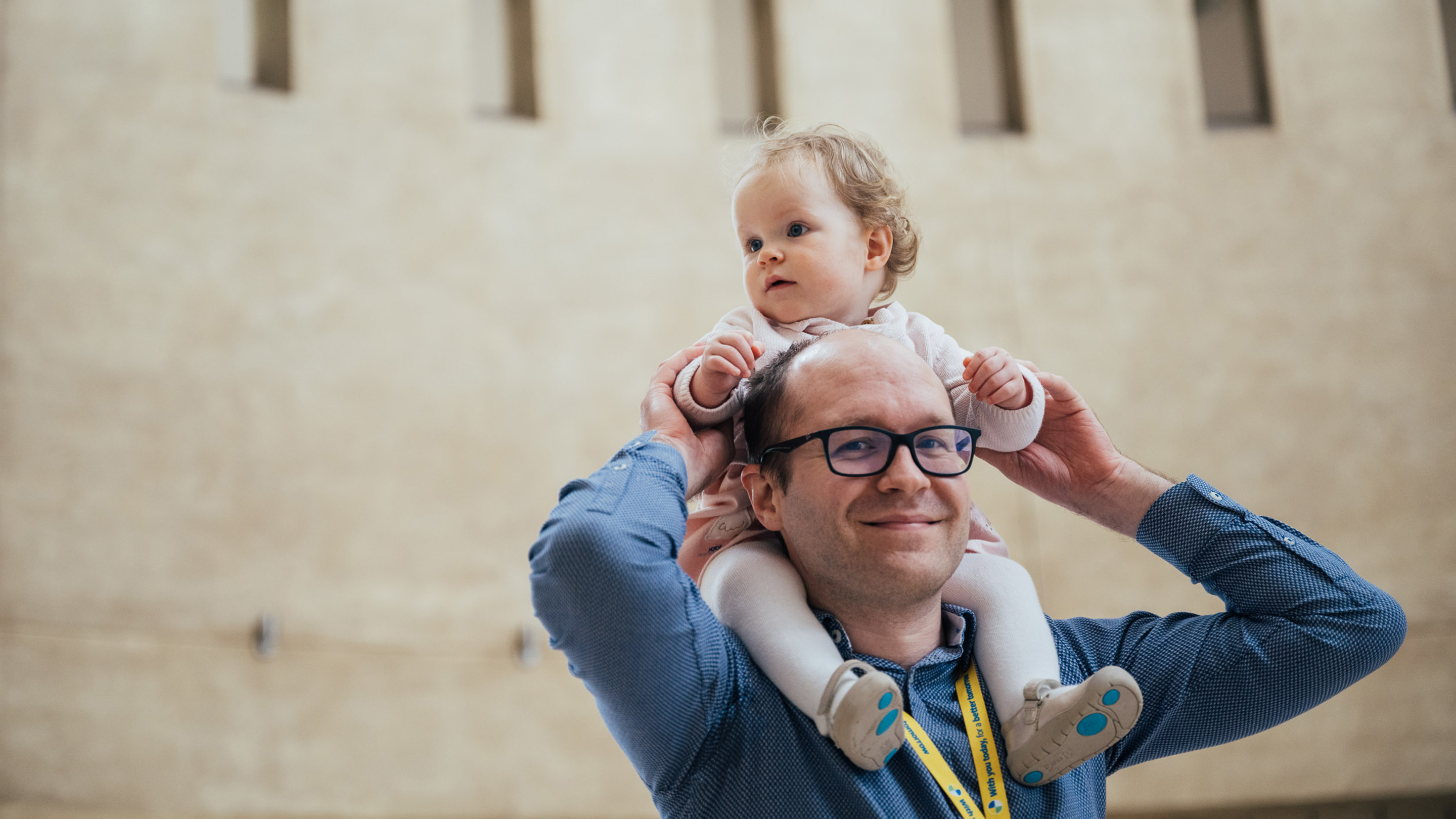 Sofia on Philip's shoulders in the rotunda in our Bristol office
