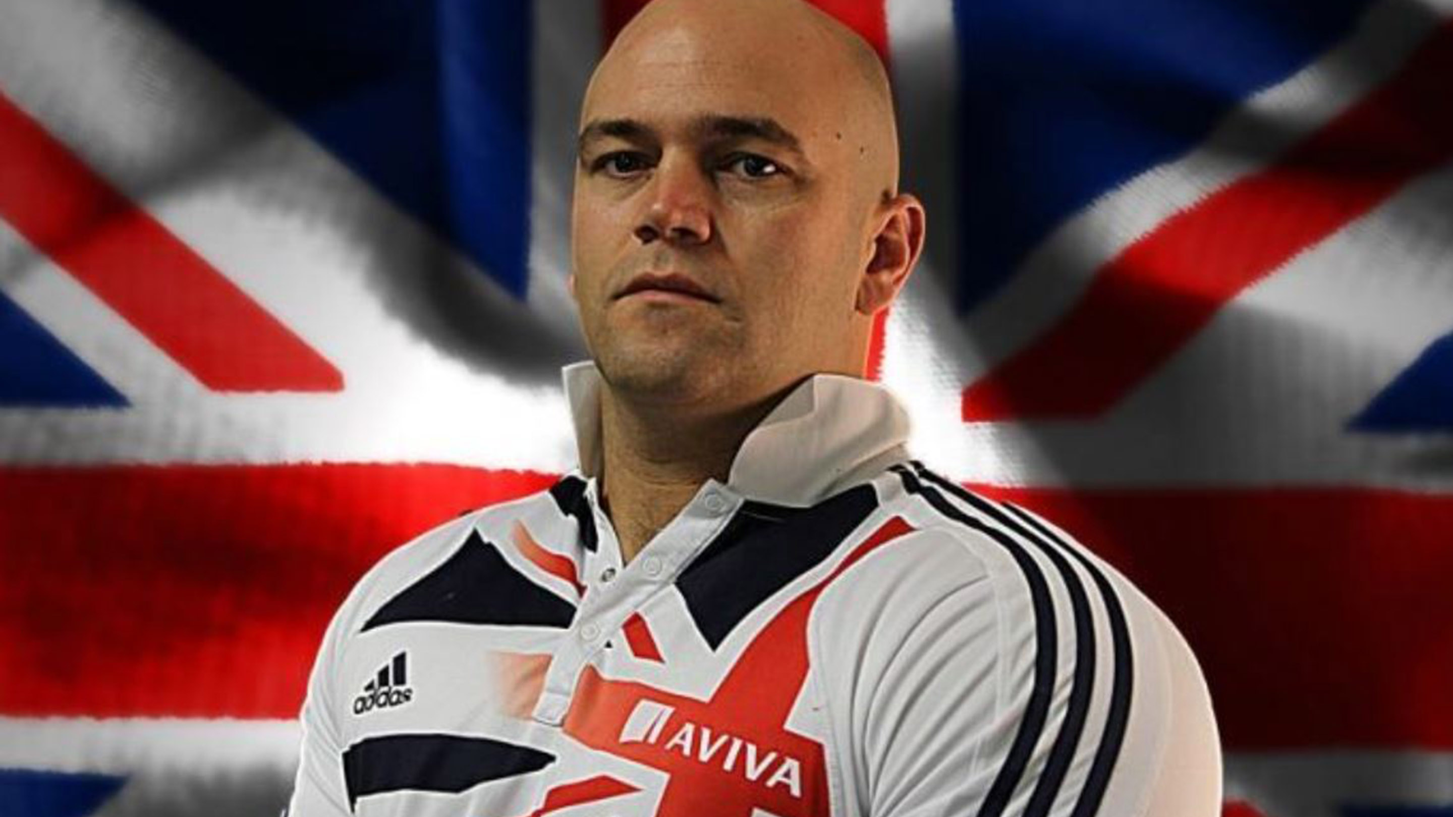 Image of Danny Nobbs wearing sponsored athletics top in front of a union flag