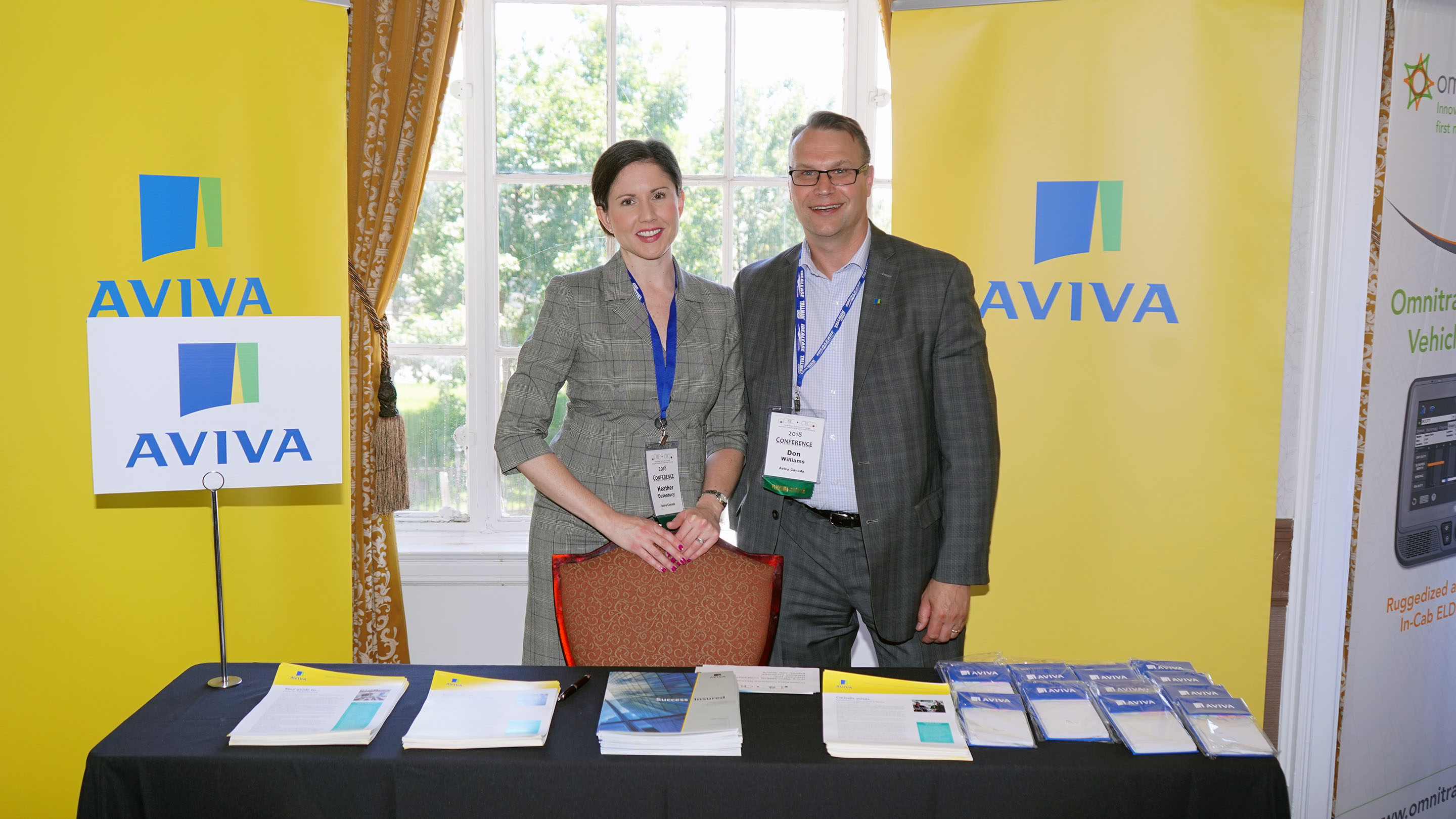 Heather and her boss, Don, at a stand at a conference