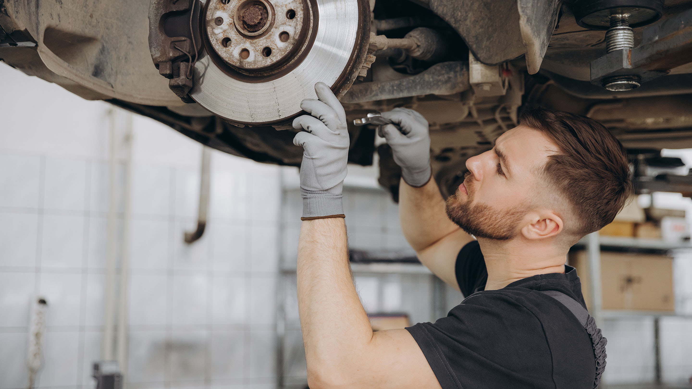 Young mechanic working on a car