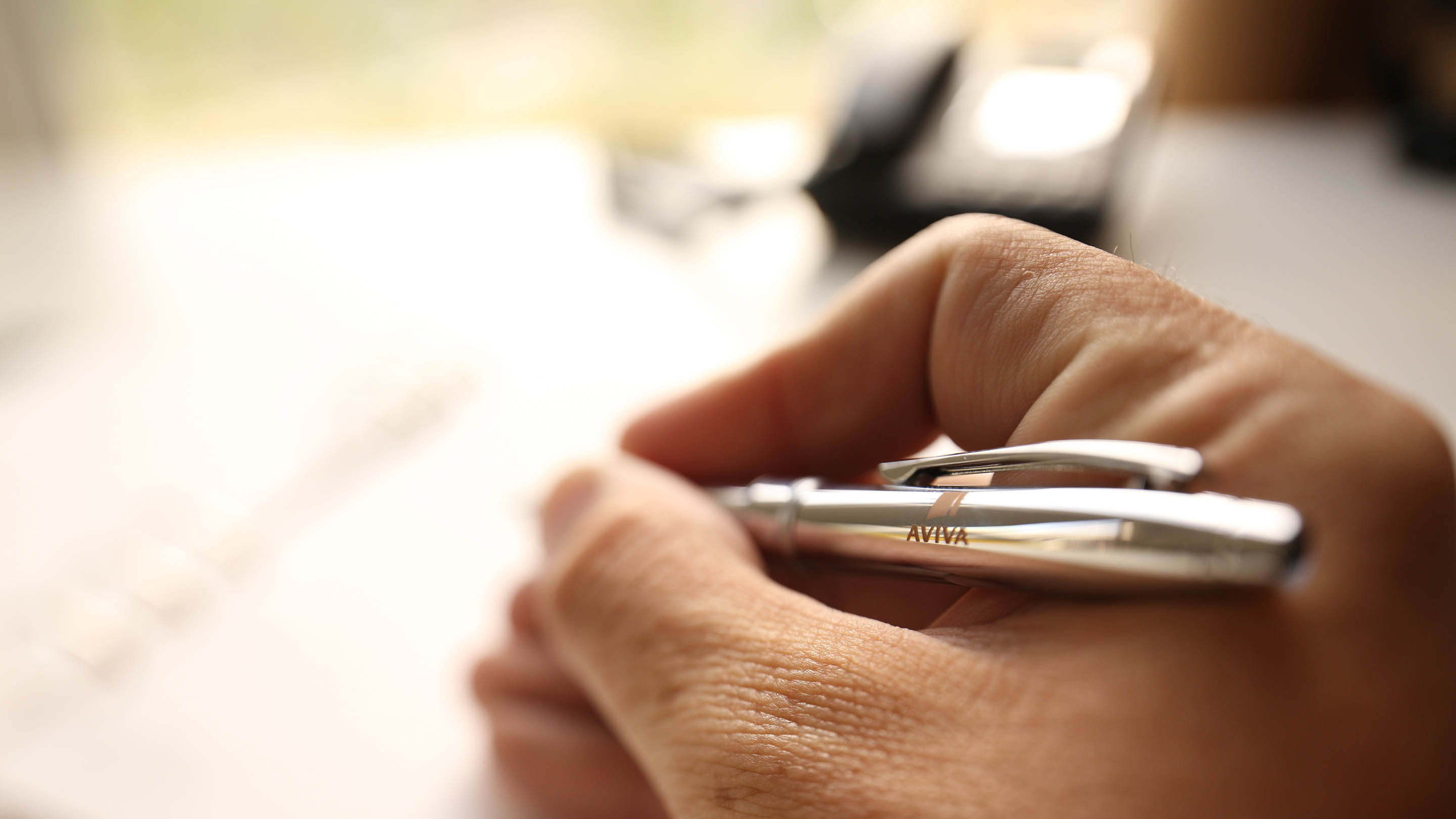 Man signing a document with a pen