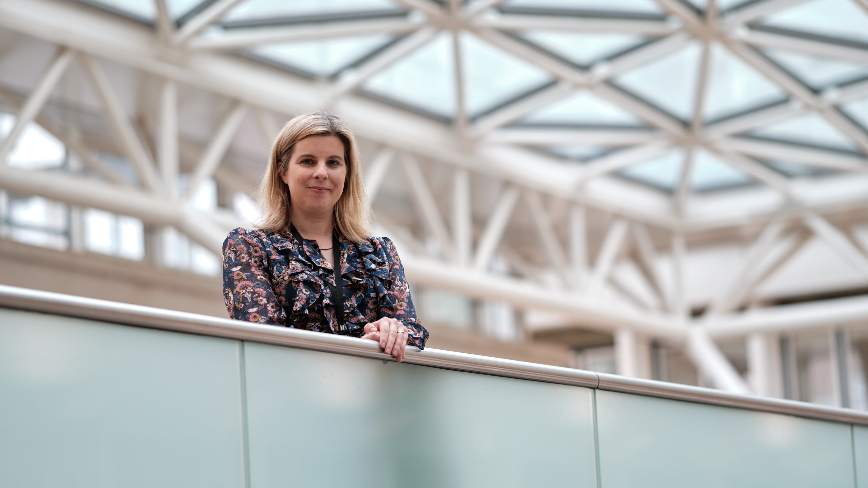 Natasha standing in the atrium of our Norwich office