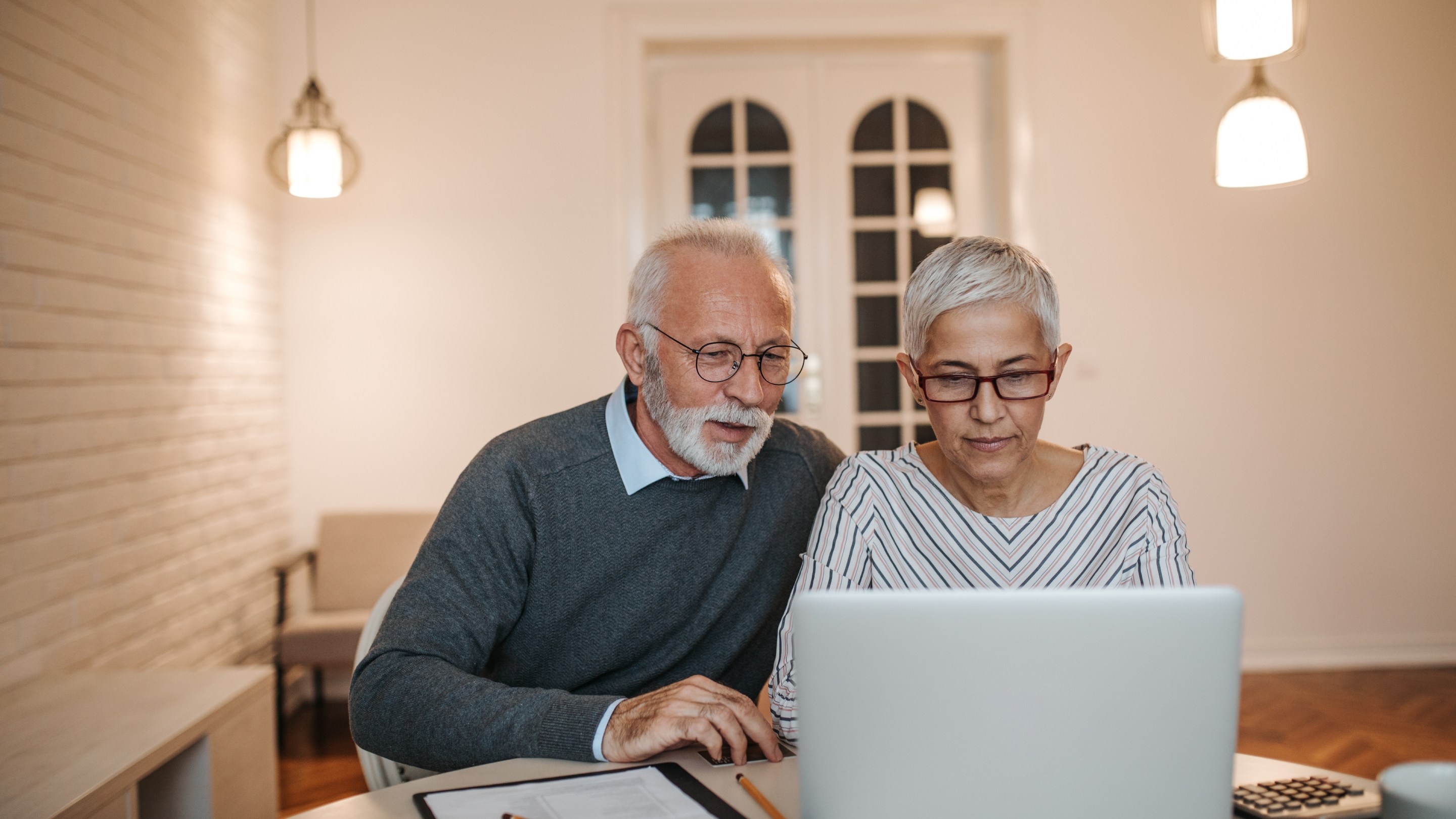 Older couple looking at laptop screen