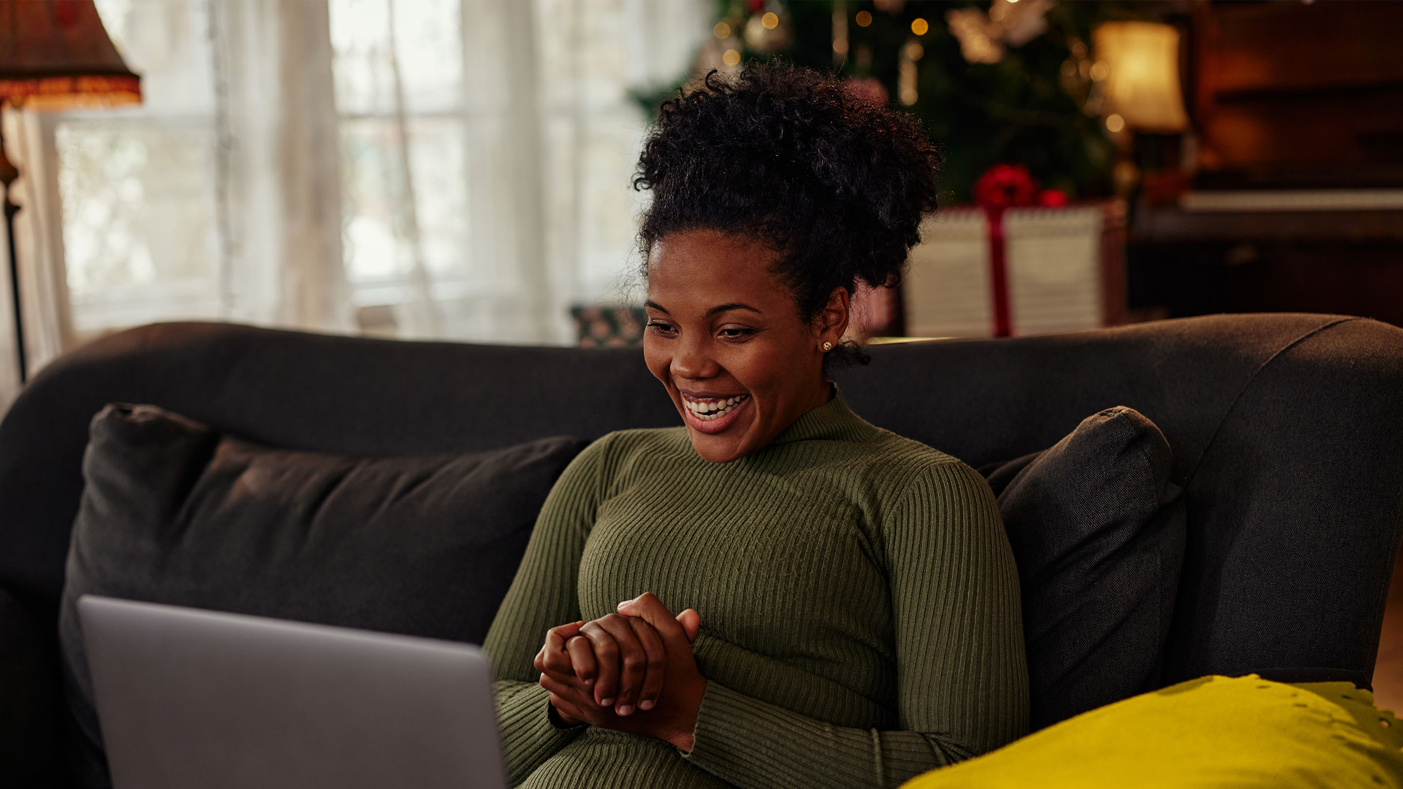 Woman enjoying Christmas time with the help of technology