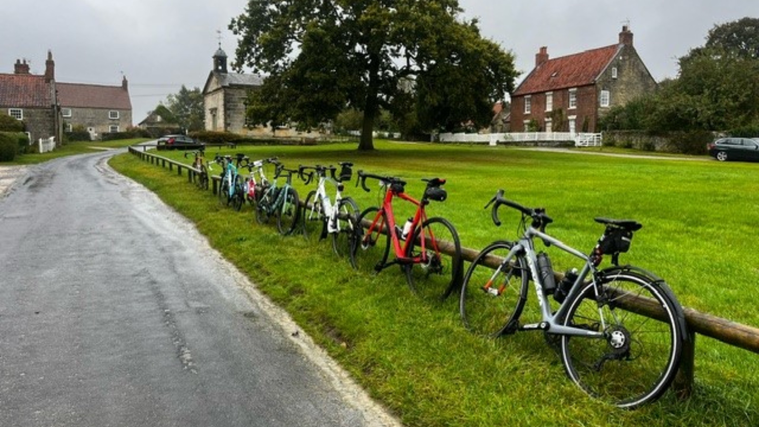 Bikes lined up on a village green