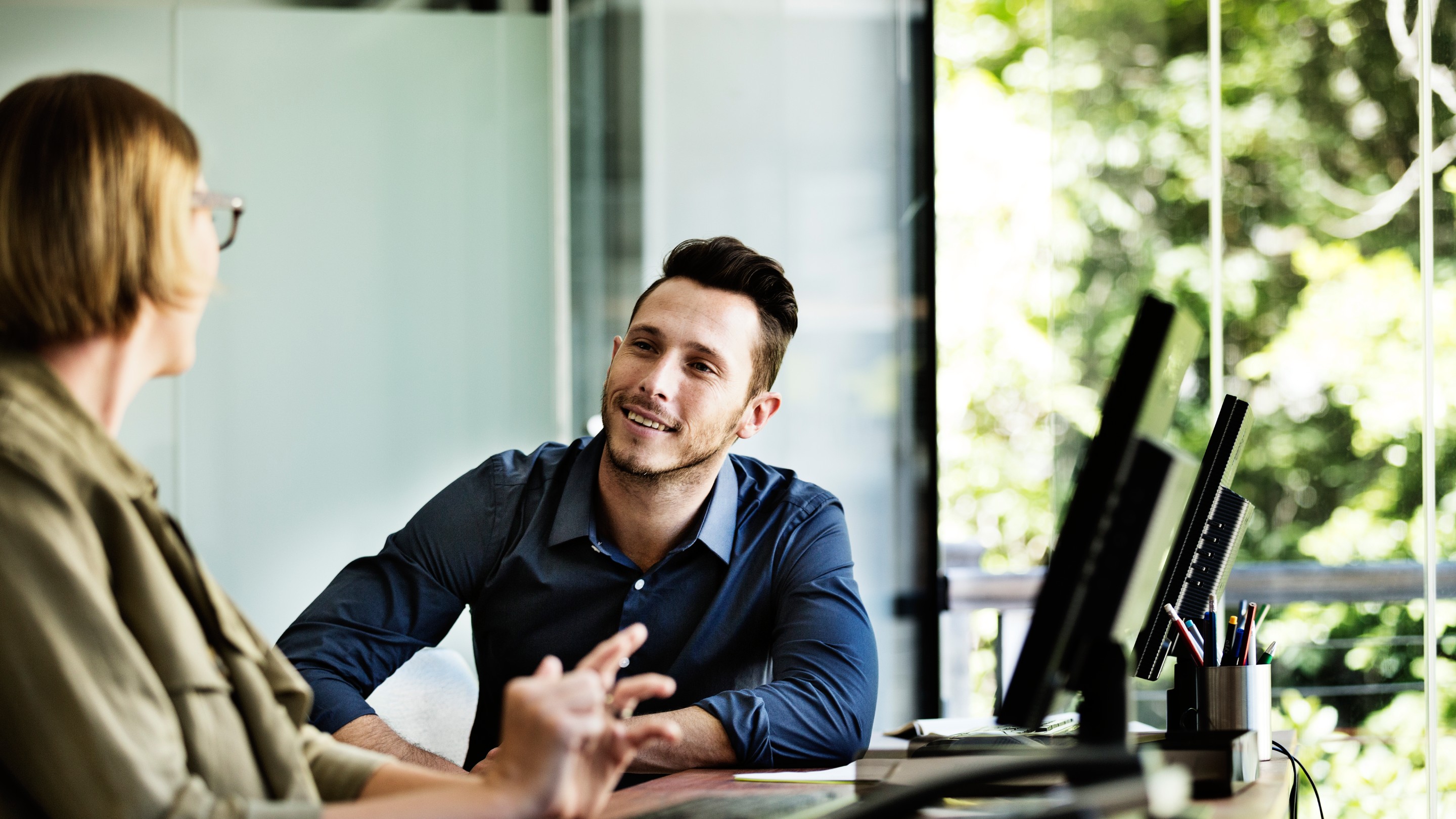 Business people discussing at computer desk